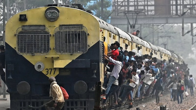 Commuters travel on an overcrowded train in Uttar Pradesh. Despite being the world's most populous nation, India's insurance industry is only the 10th largest in the world. AFP