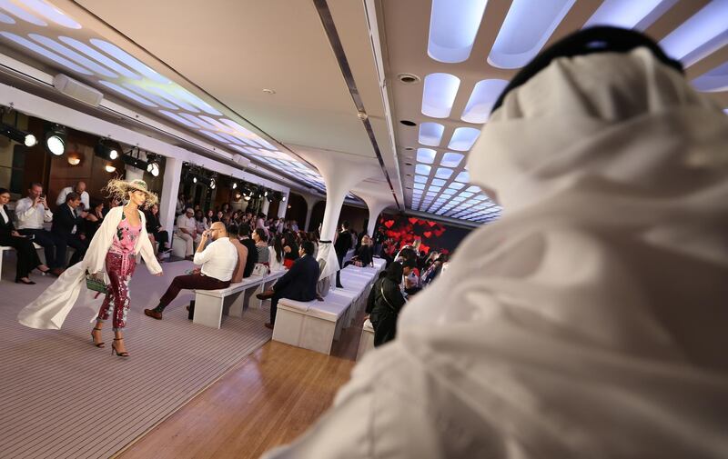 epa06724023 A model displays a creation from the collection of House of MuaMua from Italy, presented during the first floating fashion week experience of Arab Fashion Week held at Queen Elizabeth II Ship in Port Rashid Dubai, United Arab, 09 May 2018.  EPA/ALI HAIDER