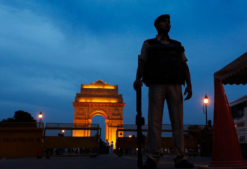 A policeman stands guard with the backdrop of the India Gate war memorial, a popular tourist place, in New Delhi, India, Thursday, July 14, 2011. Security across India is on high alert following the explosions in Mumbai on Wednesday.  (AP Photo/Gurinder Osan) *** Local Caption ***  India Explosions.JPEG-07559.jpg