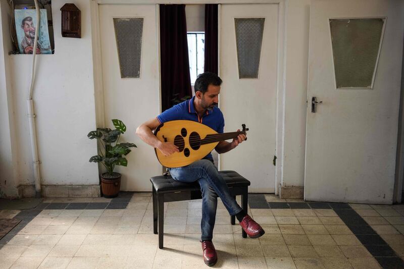 Mohammed Al Maan plays the oud in his home in the district of Adhamiyah in Iraq's capital Baghdad on April 21.  Ayman Henna / AFP