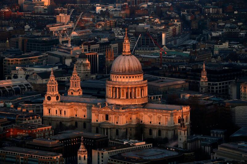 St Paul's cathedral is lit by the early morning sun in an aerial view taken from The View gallery at the Shard, western Europe's tallest building, in London January 8, 2013. The View, the public viewing deck accessible by high speed elevators on the 309 metre (1013 feet) Shard building, opens on February 1. Picture taken January 8, 2013.  REUTERS/Stefan Wermuth (BRITAIN - Tags: TRAVEL CITYSCAPE) *** Local Caption ***  CLH101_BRITAIN-_0111_11.JPG