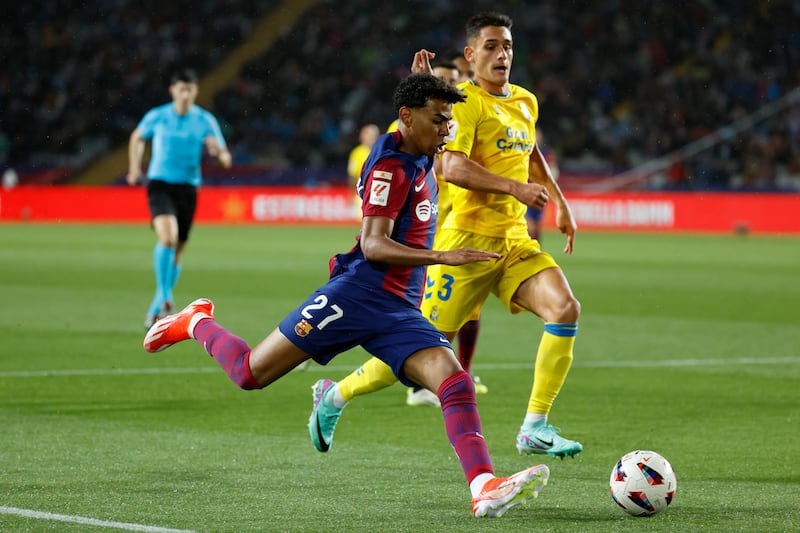 Barcelona's Lamine Yamal in action against Las Palmas' Sergi Cardona. EPA