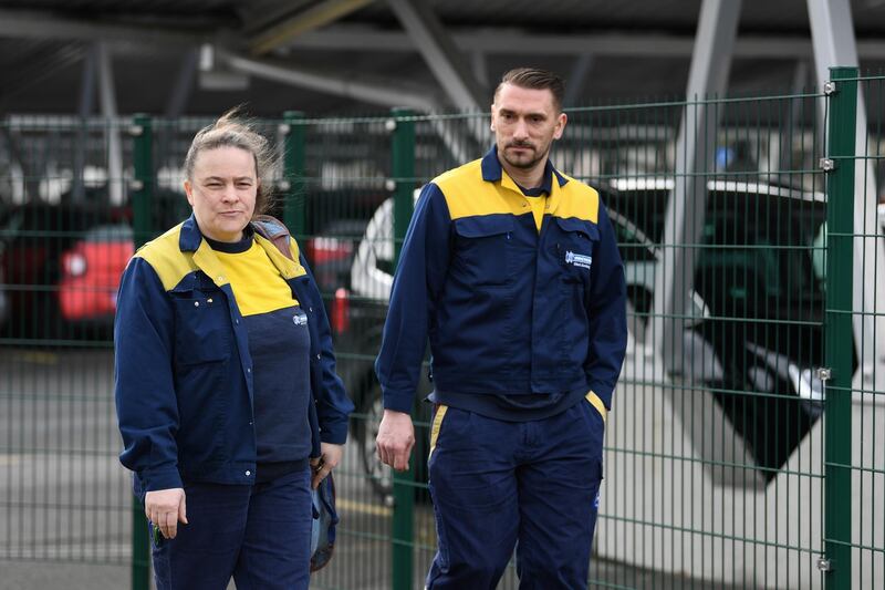 Employees Kristin and Thomas Schmitt walk towards the main gate of the Bamberg branch of French tyre manufacturer Michelin, in Bamberg, Germany, February 13, 2020. Picture taken February 13, 2020. REUTERS/Andreas Gebert