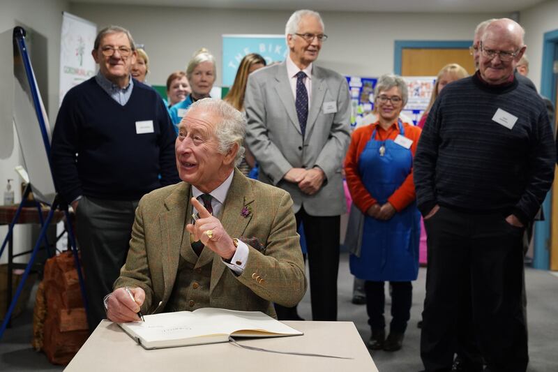 King Charles signs a guestbook. Getty Images