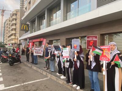 Activists hold signs outside McDonald's in Beirut. Photo: Abbas Atout.