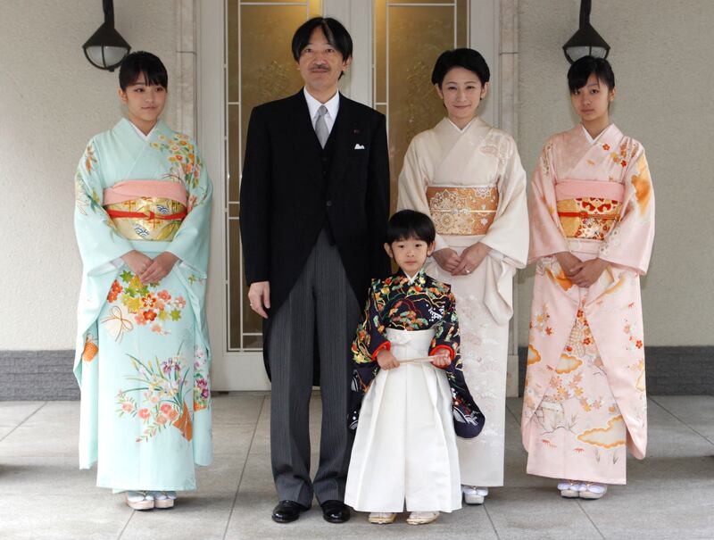 Japan's Prince Hisahito, wearing traditional ceremonial attire, is accompanied by his father Prince Akishino, mother Princess Kiko and sisters Princess Mako and Princess Kako on November 3, 2011. AFP