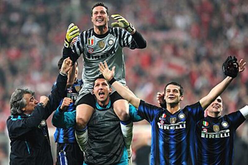 Inter Milan players celebrate after becoming only the second team in Champions League history to advance in the knockout stages after losing their home tie.