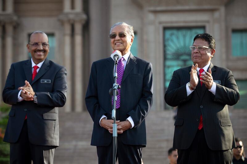 Malaysia's new Prime Minister Mahathir Mohamad, center, speaks to staffs from Prime Minister office during his first monthly assembly as prime minister in Putrajaya, Malaysia on Monday, May 21, 2018. Mahathir has unveiled a mix of senior politicians, lawyers and a lecturer in his new Cabinet after a stunning electoral victory last week. (AP Photo/Vincent Thian)