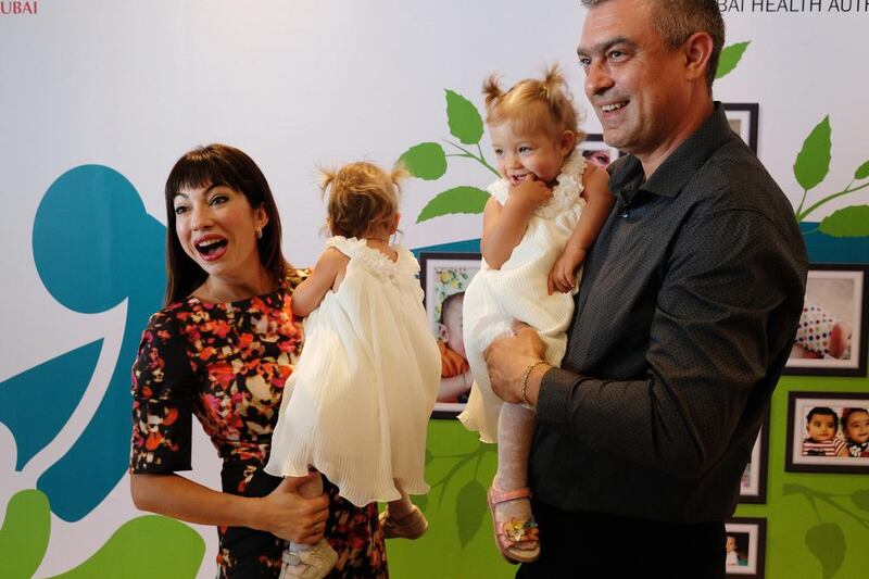 Oxana Josan and Andrei Ianovici with their twin girls Victoria and Arina. The couple turned to medical science for help after trying to conceive naturally for five years. Anna Nielsen for The National 