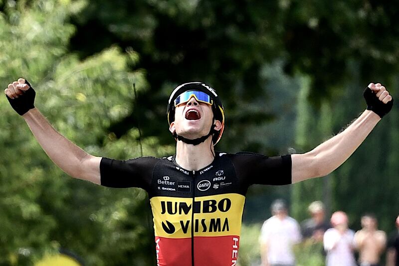 Team Jumbo Visma's Wout van Aert celebrates as he crosses the finish line to win Stage 11.