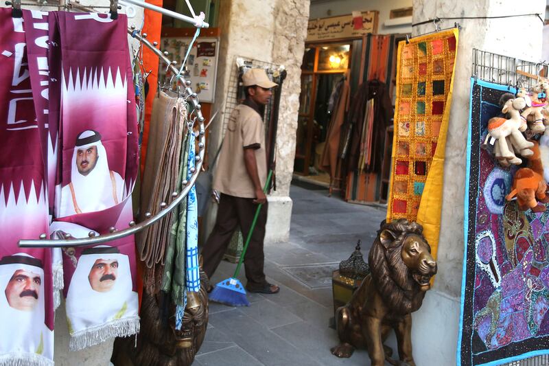 5th: Qatar. People walk past a stand displaying scarfs bearing portraits of former emir of Qatar Sheikh Hamad bin Khalifa al-Thani (bottom) and his son Sheikh Tamim (top). AFP