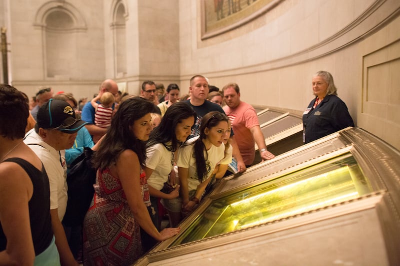 Visitors read the US Constitution on display at the National Archives in Washington. 