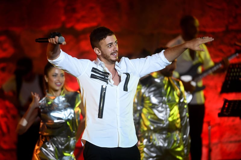 (FILES) In this file photograph taken on July 30,2016, Moroccan singer Saad Lamjarred performs during the 52nd session of the International Carthage Festival at The Roman Theatre of Carthage near Tunis. A social media campaign has been launched to ban the songs of Moroccan pop star Saad Lamjarred on the country's radio stations after he was charged in France in a third case involving rape charges. / AFP / FETHI BELAID

