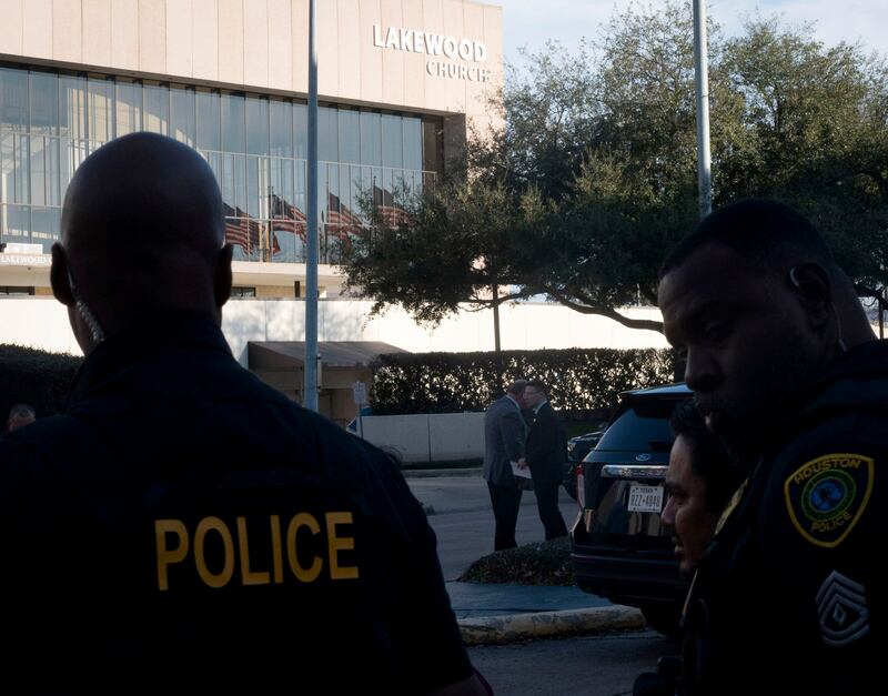 Police stand outside Lakewood Church, where a gunwoman's weapon reportedly had the words 'Free Palestine' on it. AP