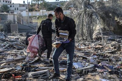 Palestinians search for their belongings amid the rubble of houses destroyed by Israeli bombs in Rafah. AFP