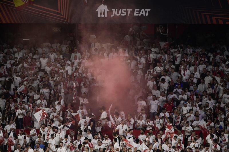 Sevilla's supporters light flares at the end of the Europa League quarter-final second leg. AFP