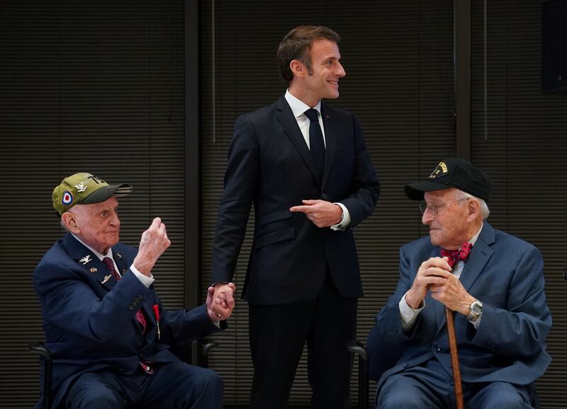 Mr Macron, Mr Felton and Mr Idelson during a ceremony honouring US soldiers who helped liberate France in the Second World War. Reuters
