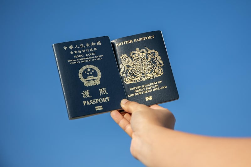 A copy of the Hong Kong Special Administrative Region (HKSAR) passport, left, with British National (Overseas) passport arranged in Hong Kong, China, on Saturday, Jan. 30, 2021. Prime Minister Boris Johnson estimates about 300,000 Hong Kong citizens will take advantage of a new visa route to leave the former British colony and settle in the U.K., despite nearly three million people being eligible. Photographer: Paul Yeung/Bloomberg