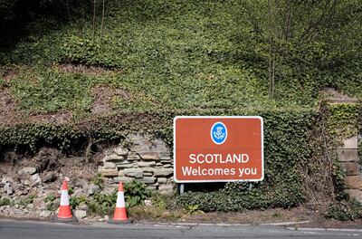 A 'Scotland Welcomes You' sign at the Scottish end of Coldstream Bridge. Photograph: Stuart Boulton