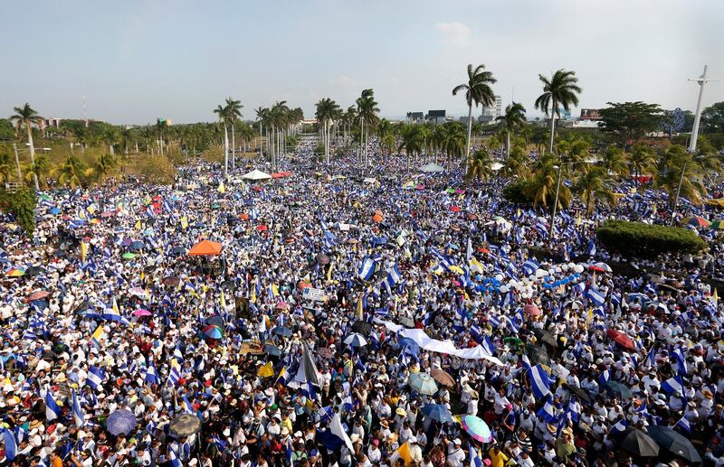 In this April 28, 2018 photo, thousands of people congregate outside Managua's Cathedral during a massive march called by the Catholic Church as a day of prayer, in Managua, Nicaragua, Saturday, April 28, 2018. Mass protests over now-scrapped social security reforms have left Nicaraguan President Daniel Ortega weakened, with even some longtime supporters saying he has turned into the sort of dictator he overthrew decades ago. (AP Photo/Alfredo Zuniga)