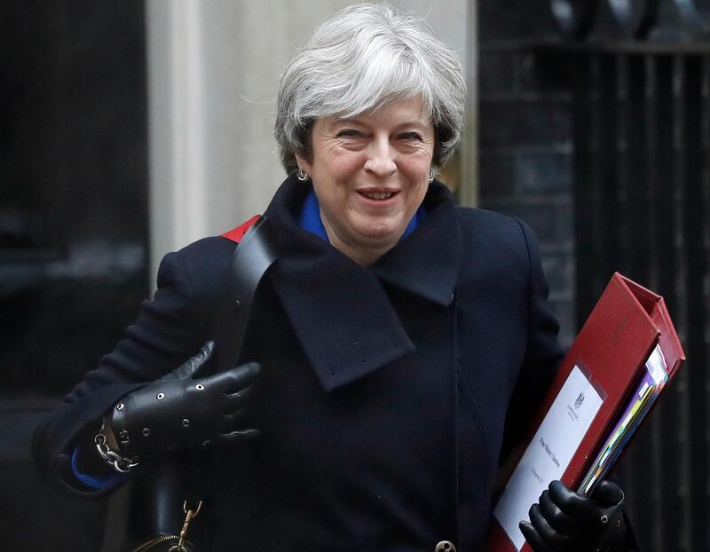 FILE - In this file photo dated Wednesday, Dec. 20, 2017, Britain's Prime Minister Theresa May leaves 10 Downing Street to attend at Parliament in London. Prime Minister May is reported Sunday Jan. 7, 2018, to have said she will re-jig the government ranks "soon," with the reshuffle of her Cabinet ahead of a crucial new phase in Brexit negotiations. (AP Photo/Kirsty Wigglesworth, FILE)