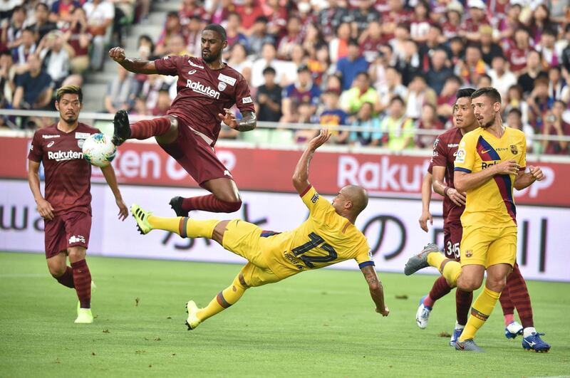 Barcelona's midfielder Rafinha  and Vissel Kobe's defender Dankler tussle for the ball. AFP