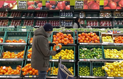 A customer shops for food items inside a Tesco supermarket store in east London on January 10, 2022. AFP