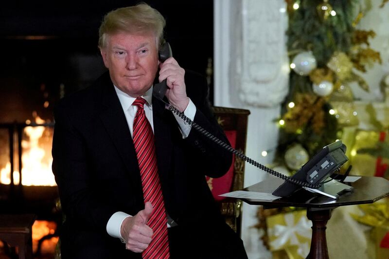 U.S. President Donald Trump participates in NORAD Santa tracker phone calls from the White House in Washington, U.S. December 24, 2018. REUTERS/Jonathan Ernst     TPX IMAGES OF THE DAY