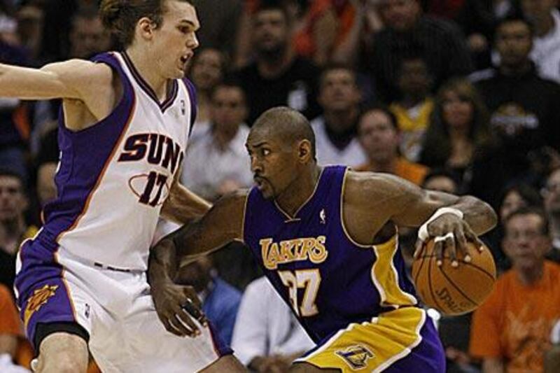 The Lakers' Ron Artest, right, tries to drive past the Suns' Louis Amundson as Los Angeles powered their way to a 102-96 win.