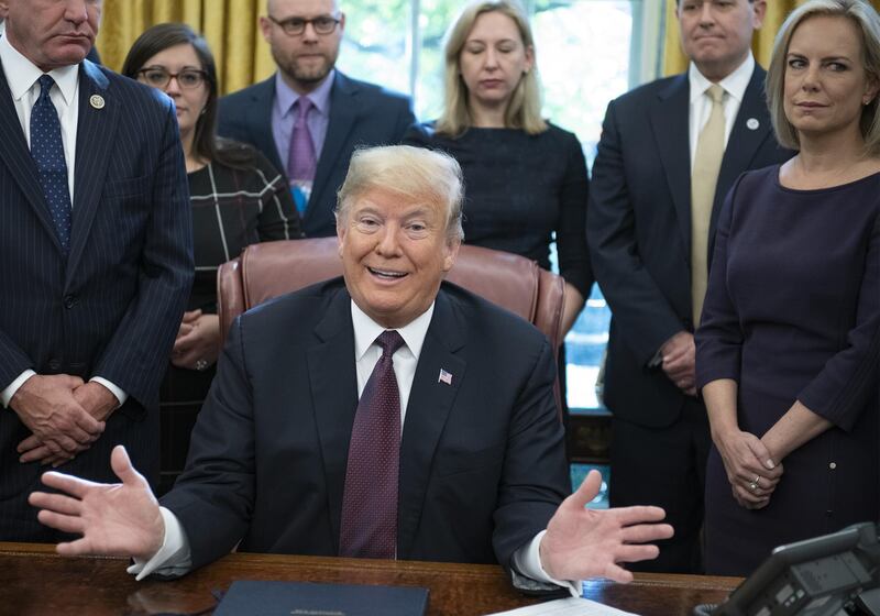 U.S. President Donald Trump speaks before signing the Cybersecurity and Infrastructure Security Agency Act in the Oval Office of the White House in Washington, D.C., U.S., on Friday, Nov. 16, 2018. Trump said that he has just finished writing answers to questions from Special Counsel Robert Mueller but hasn't submitted them yet. Photographer: Ron Sachs/Pool via Bloomberg