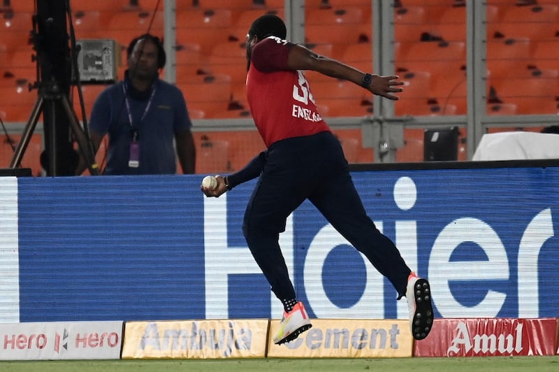 England fielder Chris Jordan takes a one-handed catch on the boundary before throwing ball to Jason Roy in one movement to dismiss India's Suryakumar Yadav for 32. AFP