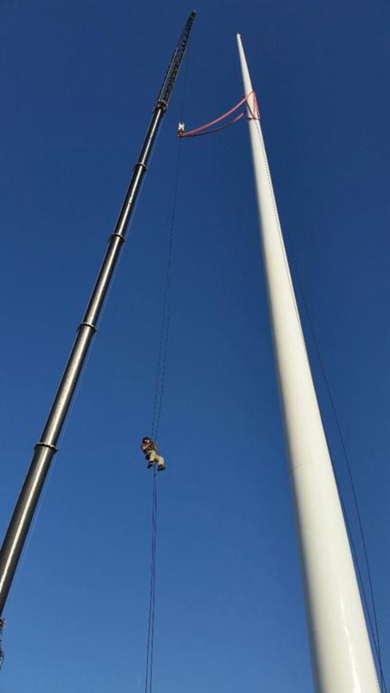 The Trident Support team work on assembling one of the two 120-metre flagpoles.