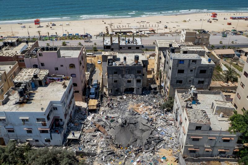 Palestinians search through the rubble of a building hit by an Israeli air strike in Gaza city. AP