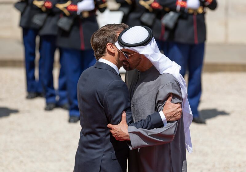 President Sheikh Mohamed and French President Emmanuel Macron embrace in the courtyard of the Elysee Palace in Paris on Monday. All photos: Chris Whiteoak / The National