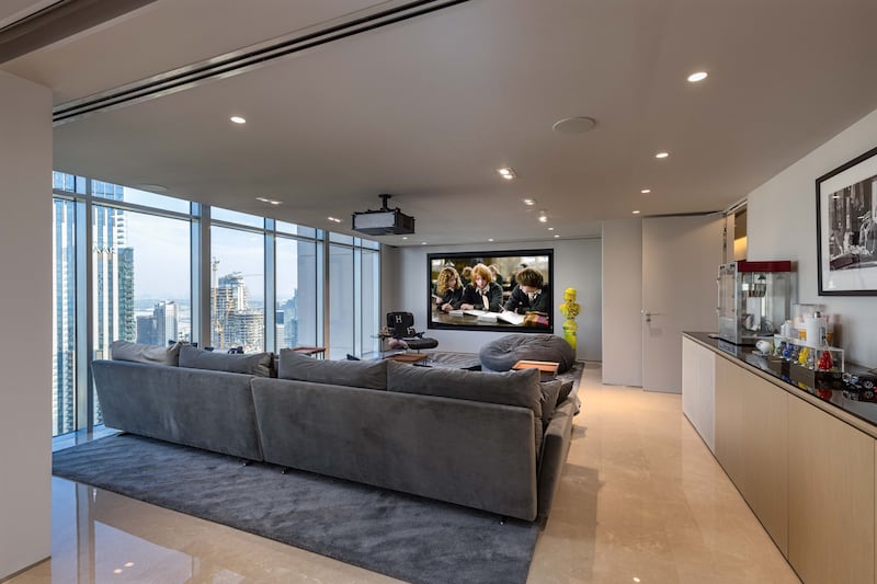 The penthouse has its own private entertainment room with a projector and large screen.