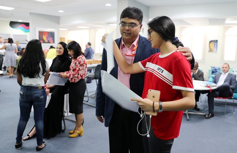 ABU DHABI ,  UNITED ARAB EMIRATES , AUGUST 22 – 2019 :- Rithika Narain ( right ) with her father after receiving the GCSE results at the Brighton College in Abu Dhabi. ( Pawan Singh / The National ) For News. Story by Kelly