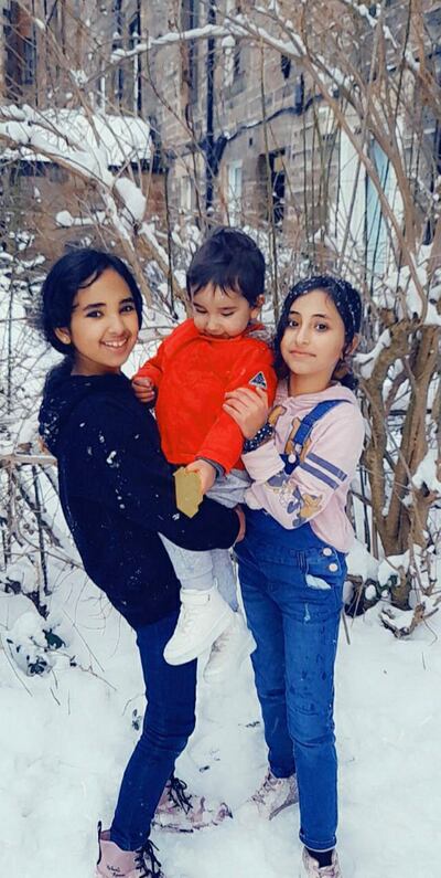 Three of the Al Hussein's four children play in the snow in Edinburgh, their home of the last two years, thanks to the VPRS. Courtesy Al Hussein family.     