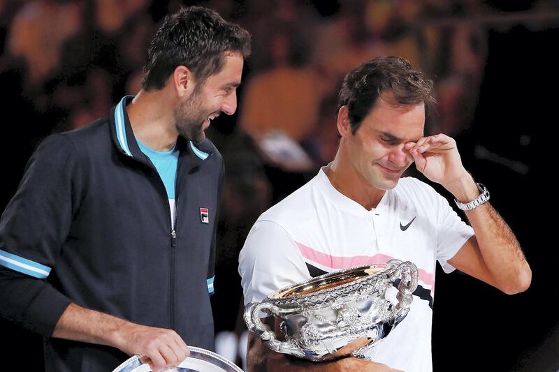 MELBOURNE, AUSTRALIA - JANUARY 28:  An emotional Roger Federer of Switzerland on stage with the Norman Brookes Challenge Cup after winning the 2018 Australian Open Men's Singles Final against Marin Cilic of Croatia on day 14 of the 2018 Australian Open at Melbourne Park on January 28, 2018 in Melbourne, Australia.  (Photo by Michael Dodge/Getty Images)