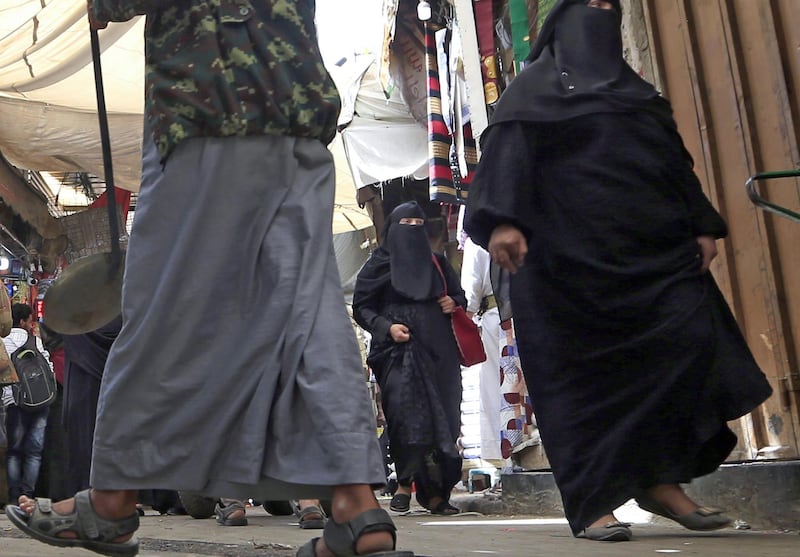 Yemeni women walk in the old city market of the capital Sanaa, on March 2, 2020. AFP