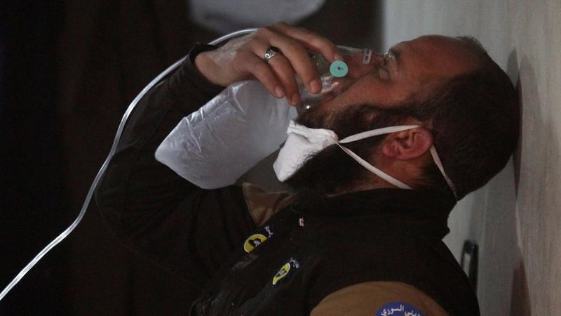 A civil defence member breathes through an oxygen mask after the sarin gas attack on Khan Sheikhoun in the rebel-held Syrian province of Idlib on April 4, 2017. Ammar Abdullah / Reuters