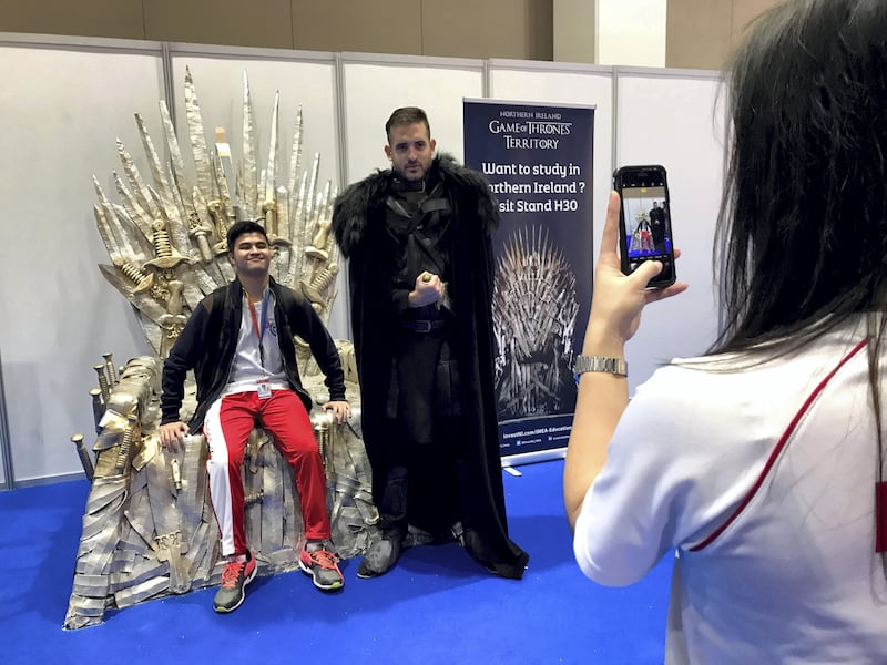 Sean Steven, 16, poses for a photo on a replica Game of Thrones chair at the Northern Ireland booth at Najah education fair on Wednesday. Roberta Pennington / The National