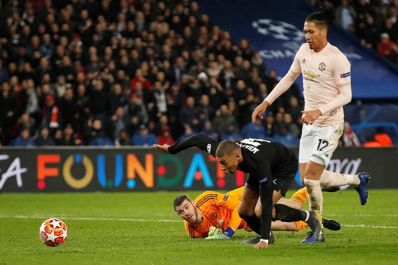 PSG's Kylian Mbappe in action with Manchester United's Chris Smalling and David de Gea. Reuters
