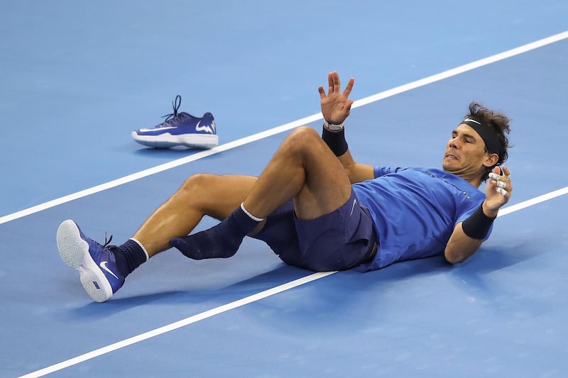 BEIJING, CHINA - OCTOBER 03:  Rafael Nadal of Spain slips fall during against Lucas Pouille of France in the Men's singles first round on day four of 2017 China Open at the China National Tennis Centre on October 3, 2017 in Beijing, China.  (Photo by Lintao Zhang/Getty Images)
