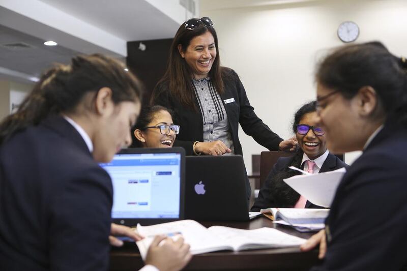 Nargish Khambatta, principal at Gems Modern Academy, shares a joke with pupils. Sarah Dea / The National 