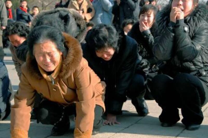 North Korean women cry after learning death of their leader Kim Jong Il on Monday, Dec. 19, 2011 in Pyongyang, North Korea. Kim died on Saturday, Dec. 17, North Korean state media announced Monday. (AP Photo/Kyodo News) JAPAN OUT, MANDATORY CREDIT, NO LICENSING IN CHINA, FRANCE, HONG KONG, JAPAN AND SOUTH KOREA *** Local Caption ***  North Korea Obit Kim Jong Il.JPEG-0be37.jpg