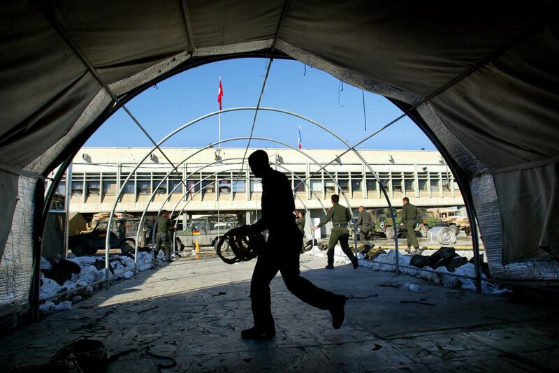 KABUL, AFGHANISTAN - FEBRUARY 7:  Turkish International Security Assistance Force (ISAF) soldiers take down their mess hall tent at the APOD military base located at the Kabul International Airport February 7, 2003 in Kabul, Afghanistan. After seven and a half months the Turkish forces are pulling out of Afghanistan and will hand over the mission to the German-Netherlands Corps on the 10th of February.  (Photo by Paula Bronstein/Getty Images)