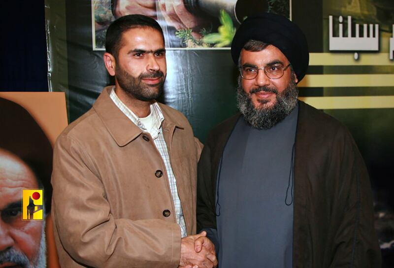 The elite commander, pictured shaking hands with Hezbollah leader Hassan Nasrallah, was killed in Israeli air strike, as the conflict at the border escalates