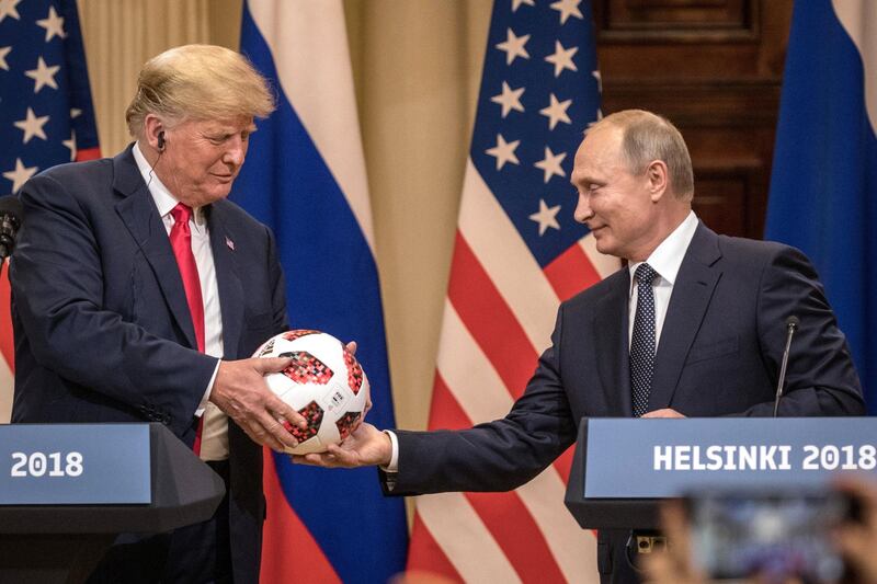 HELSINKI, FINLAND - JULY 16:  Russian President Vladimir Putin hands U.S. President Donald Trump (L) a World Cup football during a joint press conference after their summit on July 16, 2018 in Helsinki, Finland. The two leaders met one-on-one and discussed a range of issues including the 2016 U.S Election collusion.  (Photo by Chris McGrath/Getty Images)