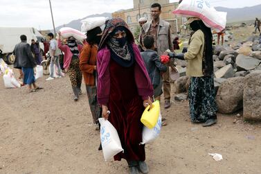 Conflict-ridden Yemenis receive food rations provided by Mona Relief Yemen at a village on the outskirts of the city of Sanaa, August 27, 2019. EPA/YAHYA ARHAB