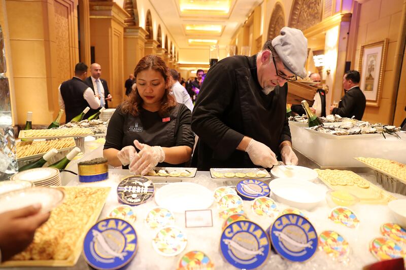 Staff serving food during the Michelin Guide Abu Dhabi restaurants announcement held at Emirates Palace in Abu Dhabi. Pawan Singh / The National 